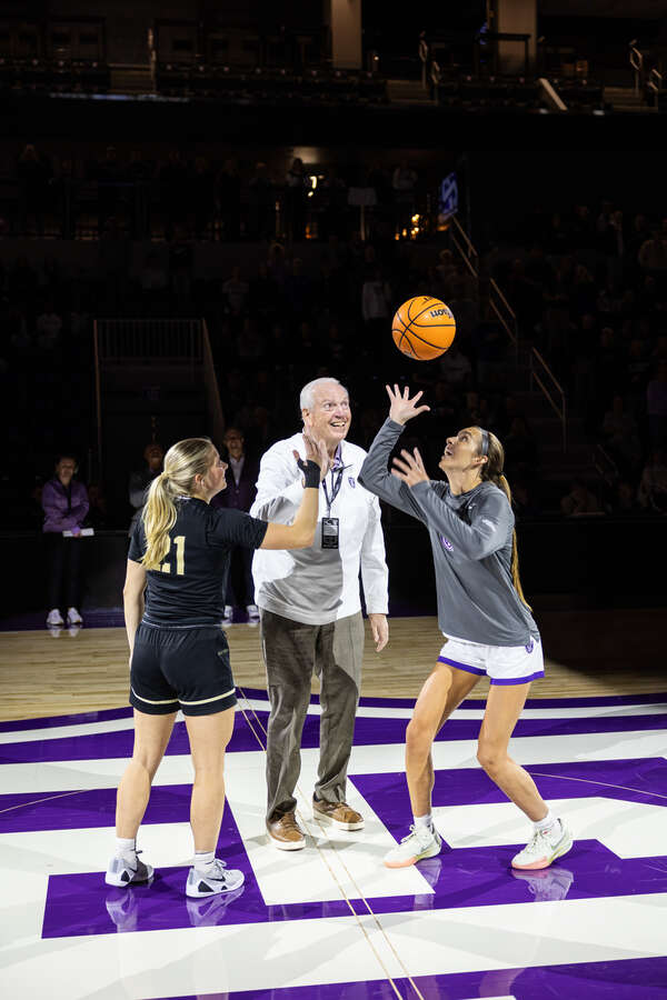 A ceremonial basketball tip off