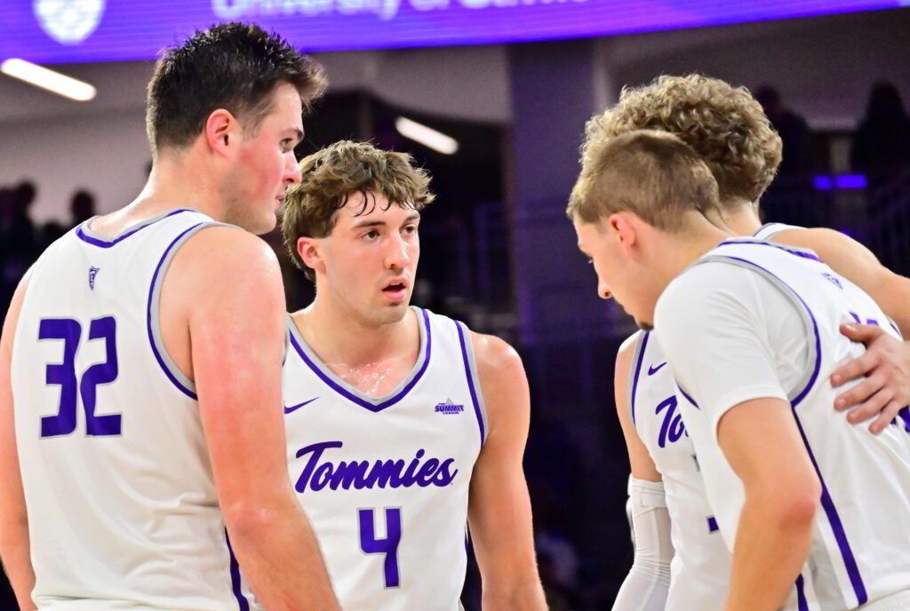 Four St. Thomas players huddle