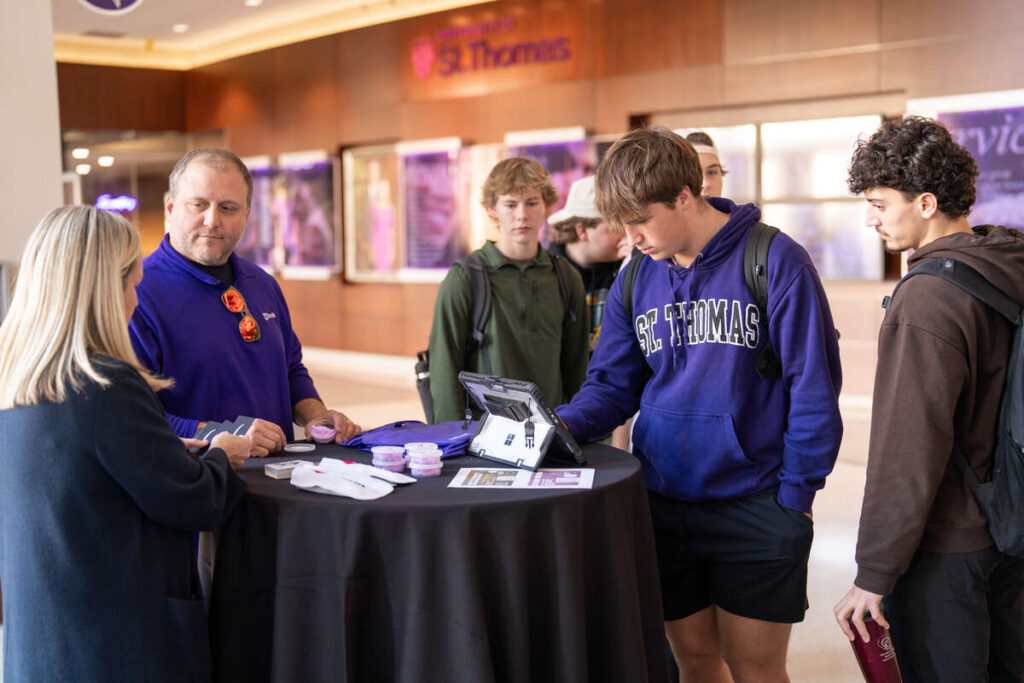 Students standing at table