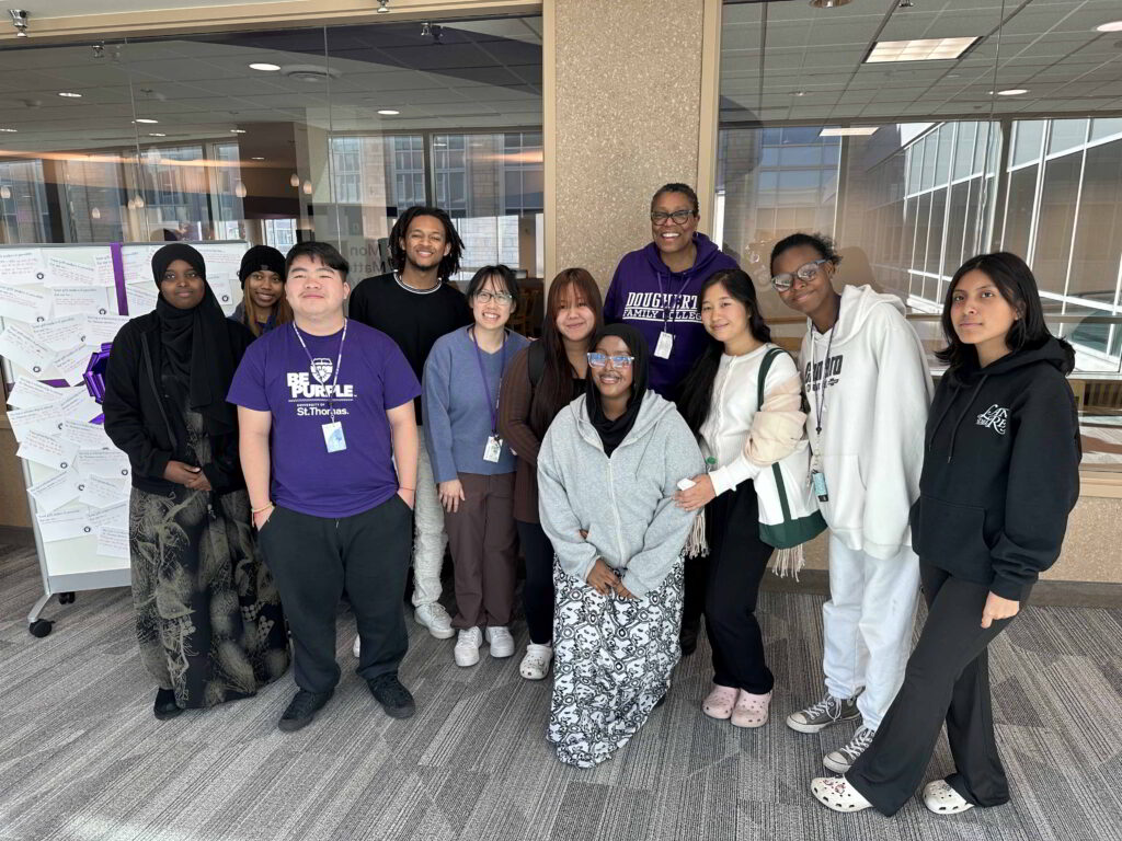 A group of students smile.