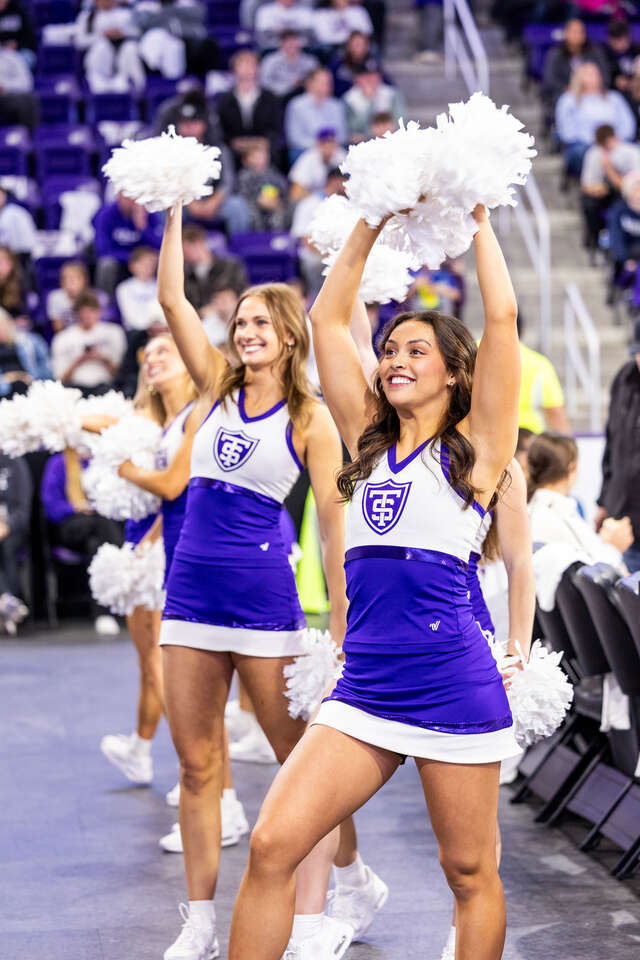 The dance team holding up pom-poms