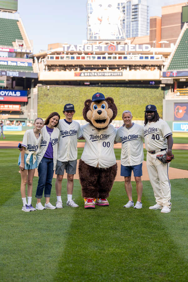 Phil Esten, Vice President, Director of Athletics, his family, TC, and Tommy Watkins pose for a photo at the St. Thomas Night with the Twins at Target Field on May 7, 2025 in Minneapolis.