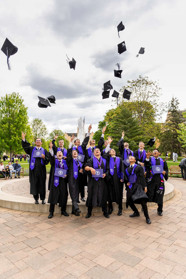 Students toss their caps after the Undergraduate Ceremony for College of Arts & Sciences on May 24, 2025 in St. Paul.