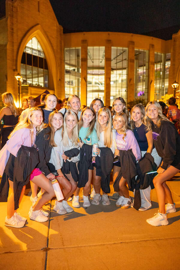 Students pose for a photo at the Outdoor Movie, Bonfires & S'mores Welcome Week activities on Monahan Plaza and the lower Quad on Aug. 26, 2025 in St. Paul.