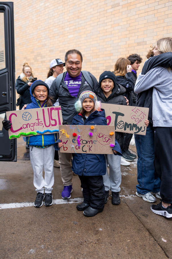 Coach Thanh Pham and family pose for a photo as the St. Thomas Women’s Volleyball team celebrates after they return from winning the Summit League Championship as the first team in our Division I era to qualify and earn an automatic bid to the NCAA Tournament outside of the Anderson Athletic and Recreation Complex on Nov. 26, 2025, in St. Paul.