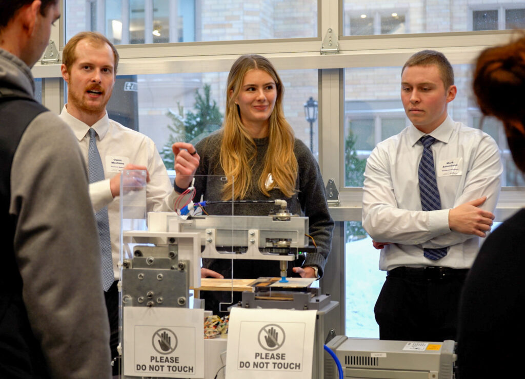 A team talks to a guest visiting their station