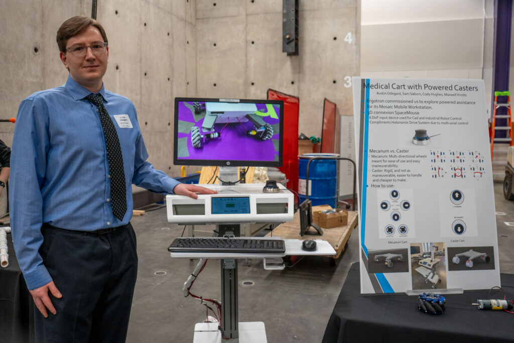 Austin Odegard '25 stands near his team's project