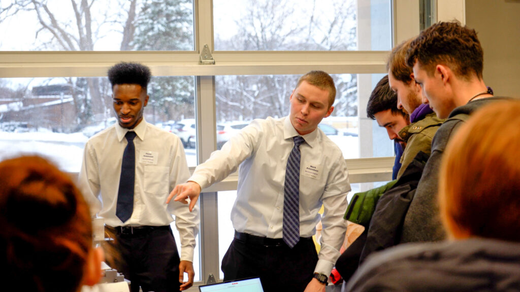Mark Amundson pointing something out while presenting his team's project.