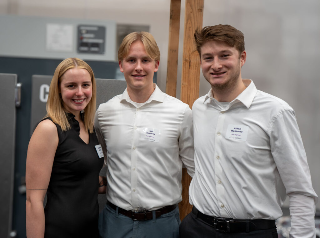 Three students smile for group photo