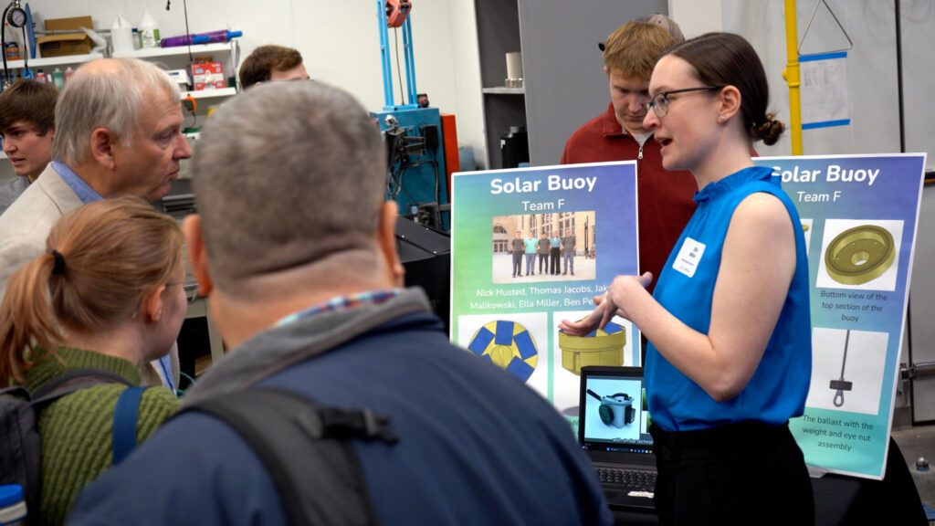 Visitors gathered around a team's booth.