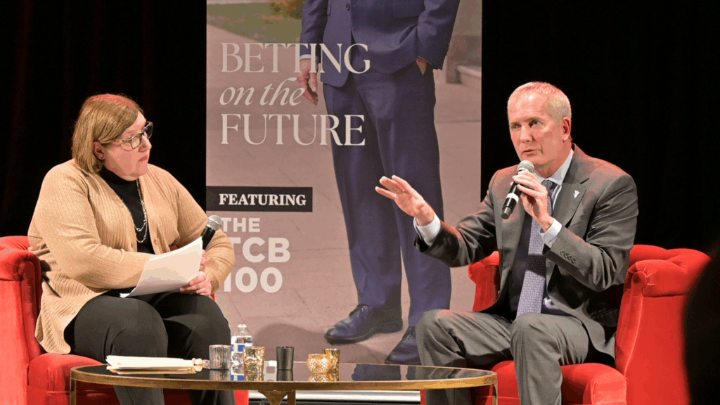 Senior Editor Liz Fedor (left) interviewing St. Thomas President Rob Vischer (right) on stage at the Twin Cities Person of the Year event.