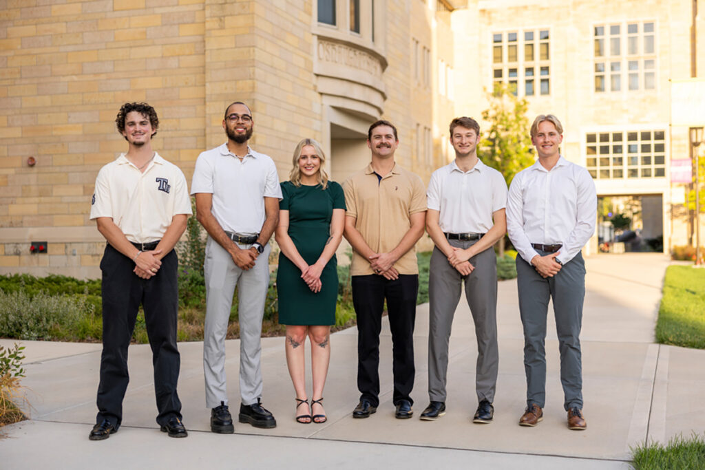 Six students stand next to each other for a group photo.