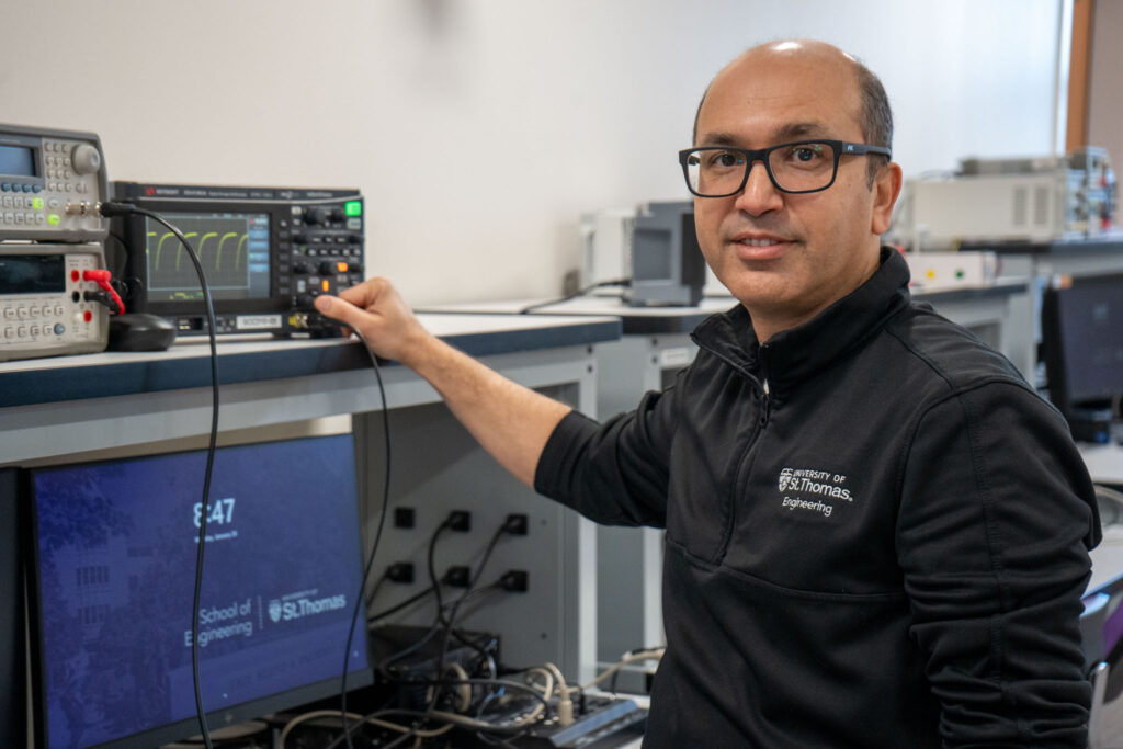 Kundan Nepal standing in front of gear in engineer lab