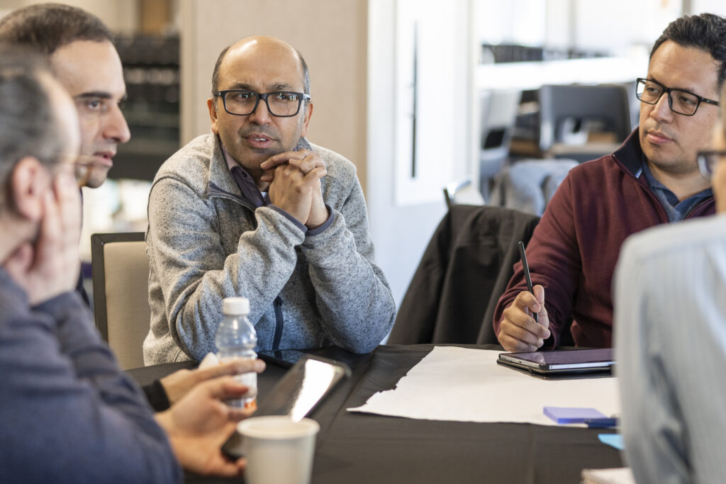 A group of faculty members sit together.