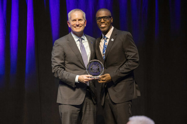 Rob Vischer hands alum Teron Buford an award