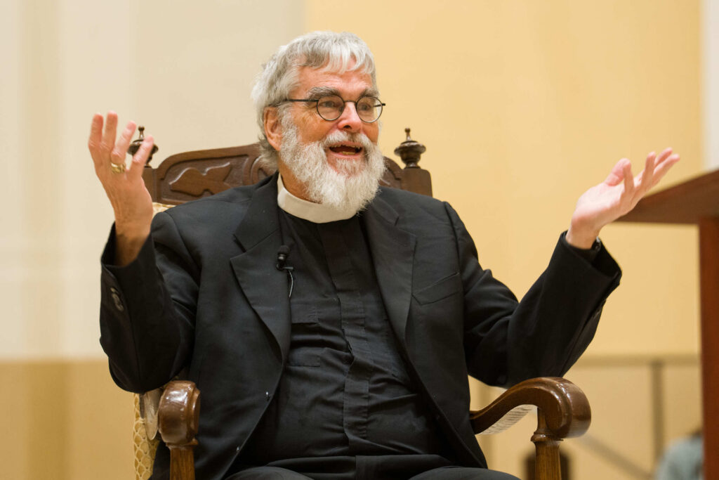 Astronomer Brother Guy Consolmagno talks with his hands while sitting