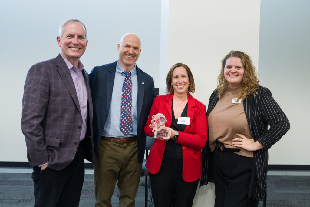 A group photo of four people.