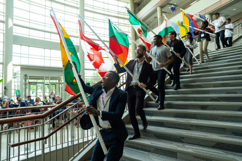 International students carry in flags from their countries