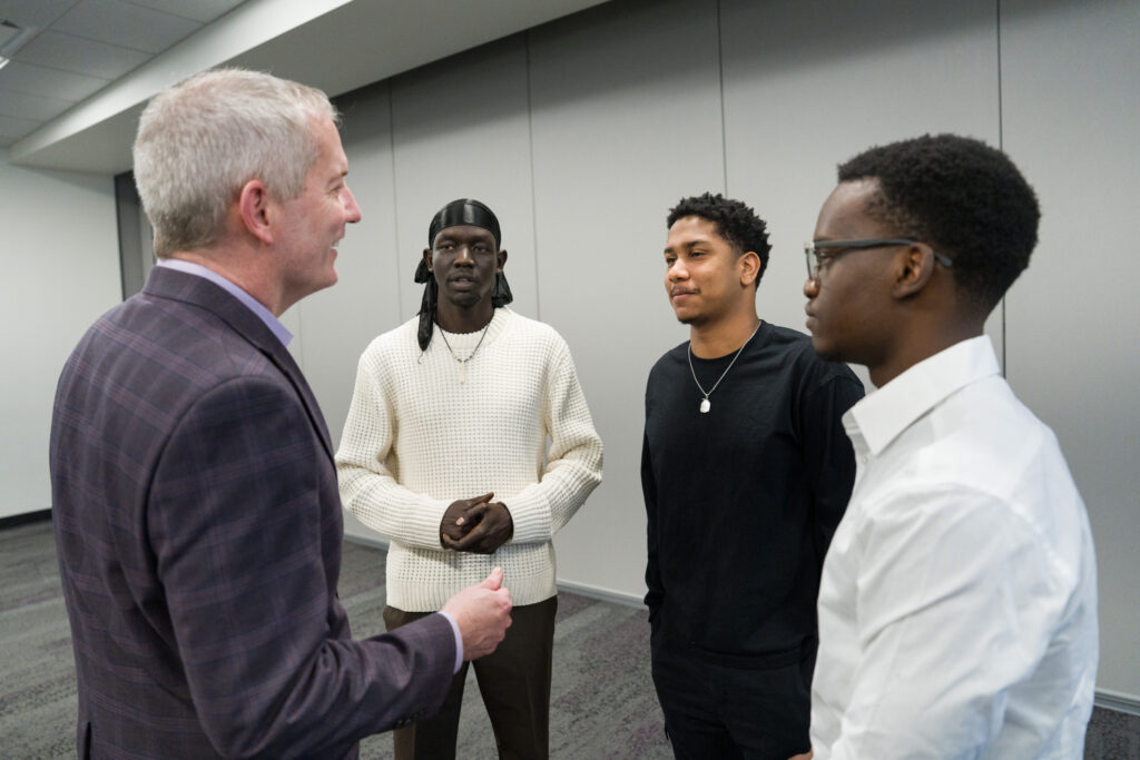 President Rob Vischer chatting with three Davis UWC scholars.