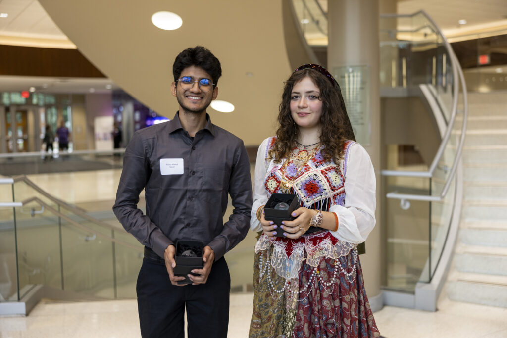Raian Khaled Navid and Sofia Compagnoni pose for a photo.