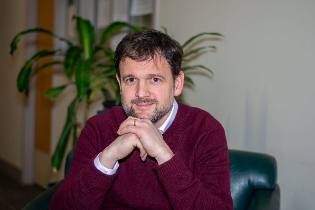 Tom Feeney sits in a chair.