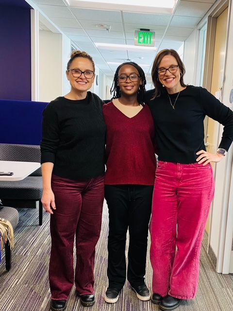 Vane Gichana standings next to two people.