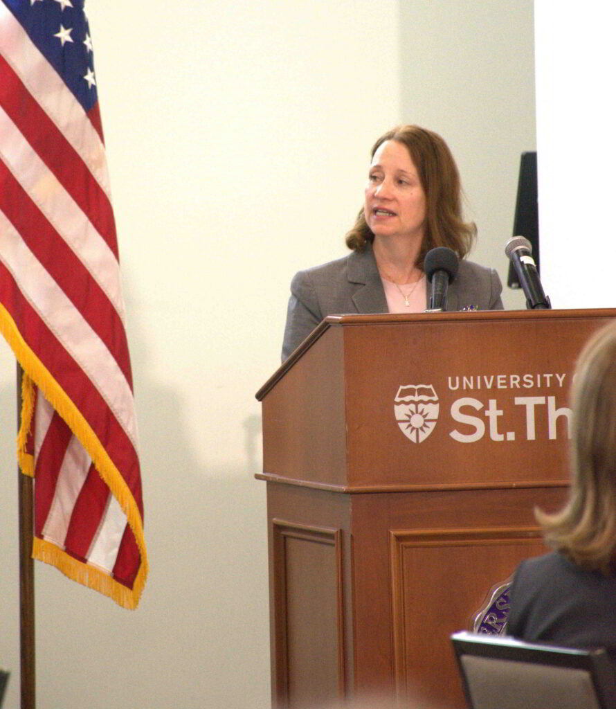 An individual speaks at the podium.