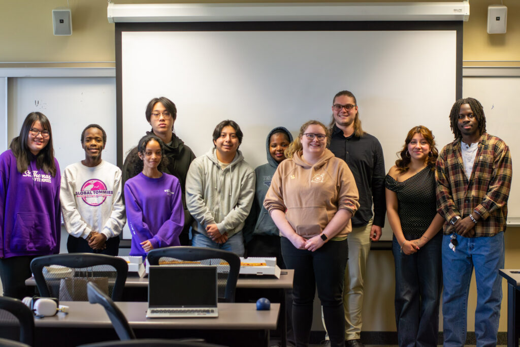 Students photo op with St. Thomas alumni Matthew Jerrard.