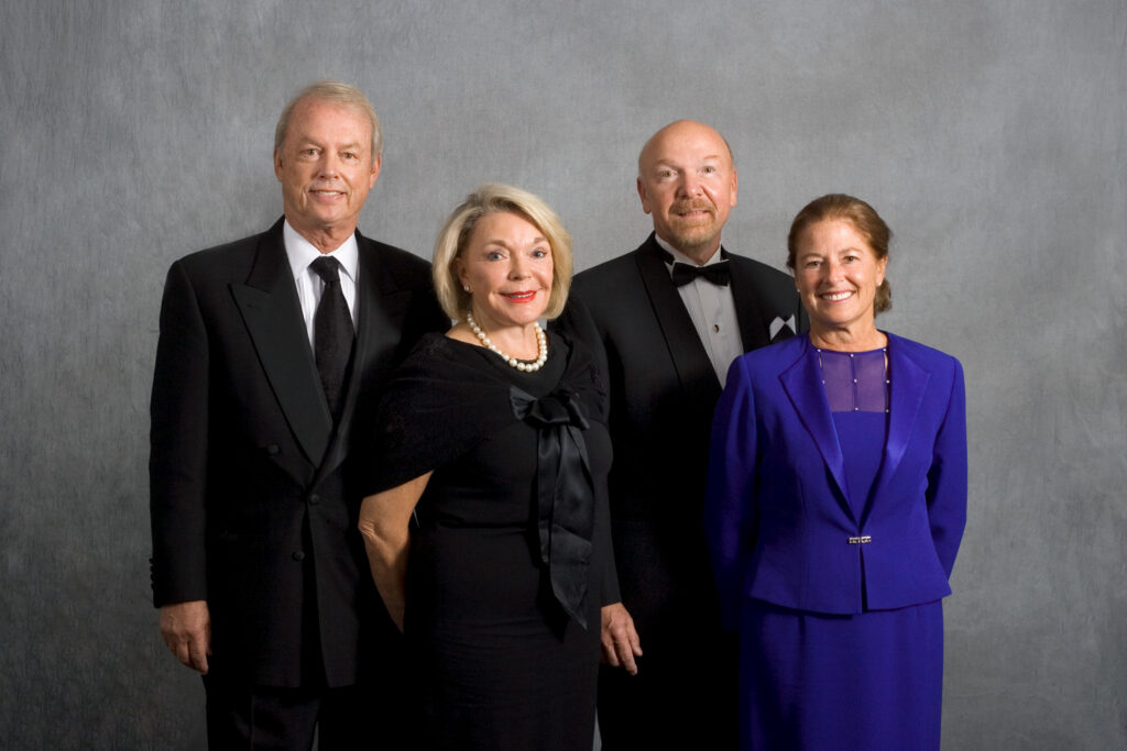 John and Susan Morrison standing alongside Richard and Maureen Schulze for a portrait.