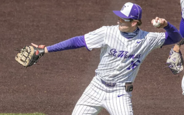An infielder for St. Thomas attempts to throw a baseball.