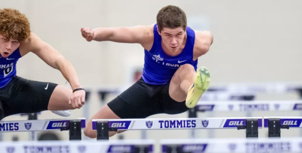 St. Thomas track athletes performs a hurdle.