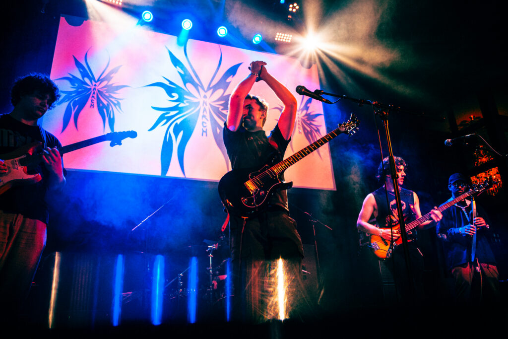 Benjamin Barrett performs on stage with his band, Monarch.
