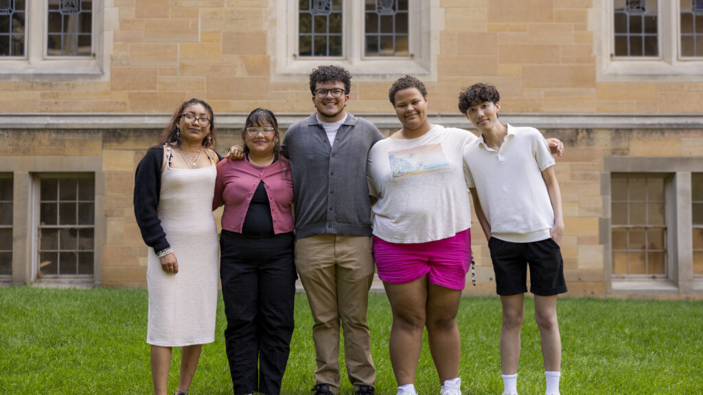 Group photo of five Excel Scholars taken outside the O'Shaughnessy-Frey Library Center.