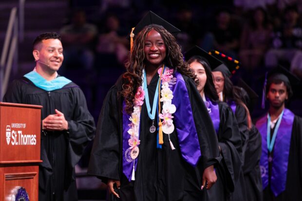 A Dougherty Family College student walks across the stage during the Dougherty Family College Commencement Ceremony at Lee & Penny Anderson Arena in St. Paul on May 24, 2026.
