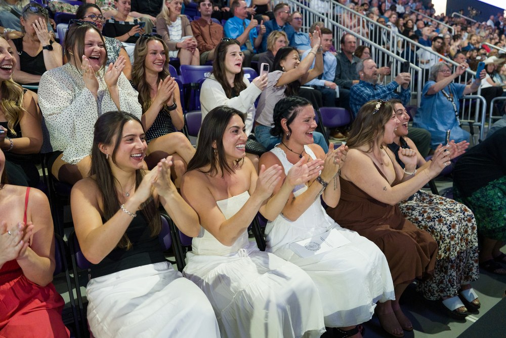 A group claps at commencement.