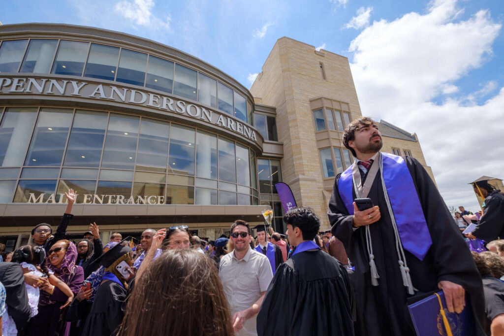 A graduate looks for his family at the COLLEGE OF ARTS AND SCIENCES UNDERGRADUATE CEREMONY in the Lee & Penny Anderson Arena in St. Paul on May 23, 2026.