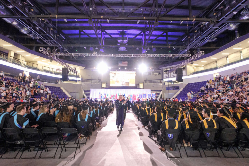 President Rob Vischer applauds the grad students after the College of Arts & Sciences, School of Divinity, School of Engineering, School of Education Graduate Commencement Ceremony in the Lee & Penny Anderson Arena in St. Paul on May 24, 2026.