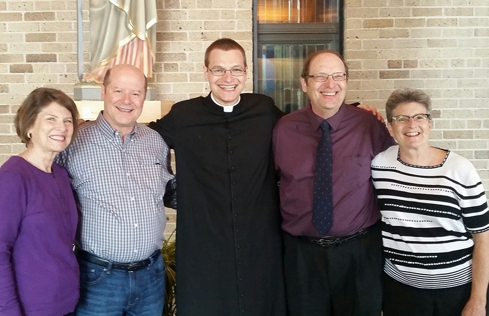 A family photo of Claudette, Marty, Father Paul, Father Paul's father Mike, and Janie.