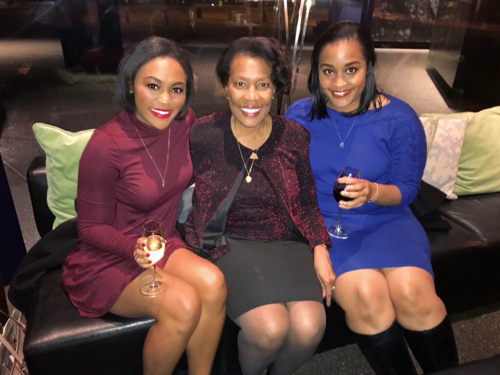 Lara Marion sits on a couch next to her mother (center) and sister.