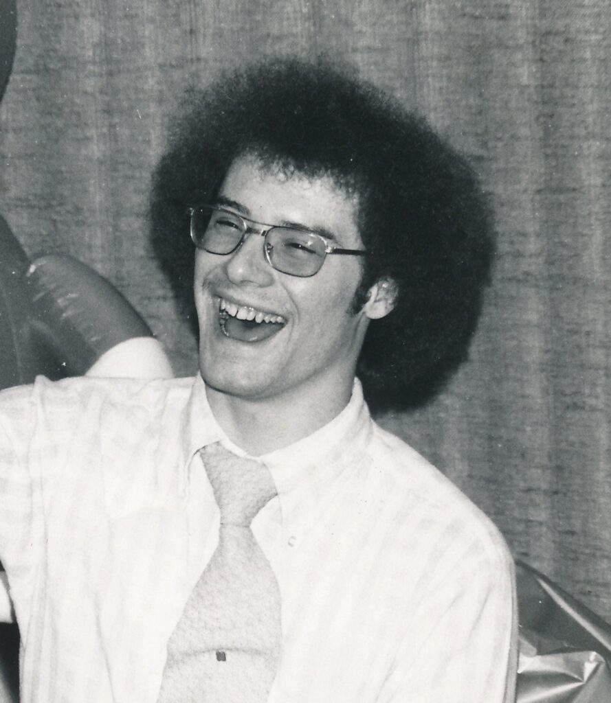 A black and white photo of Martin Strommer smiling in 1975.