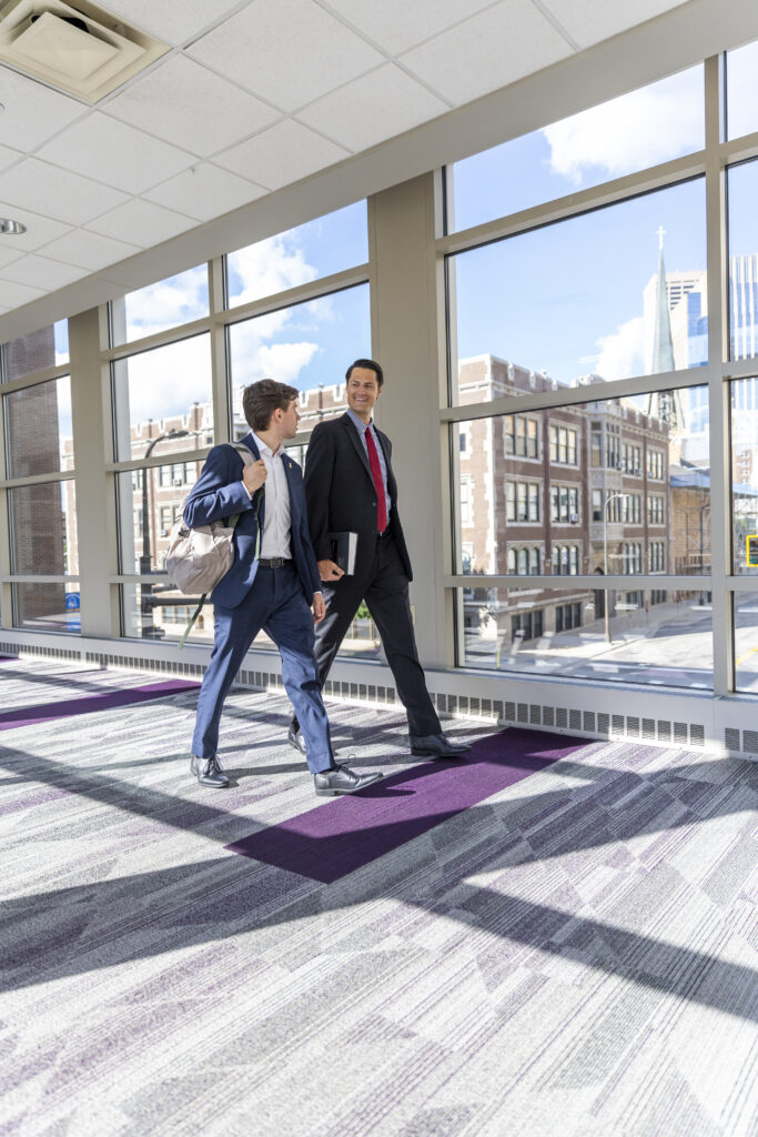 Two law students walk across the St. Thomas skyway.