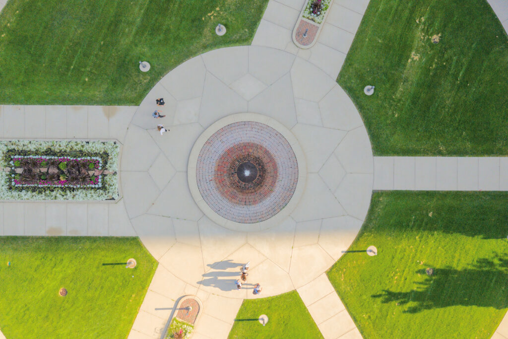 A birds eye view of students walking across the School of Law plaza.