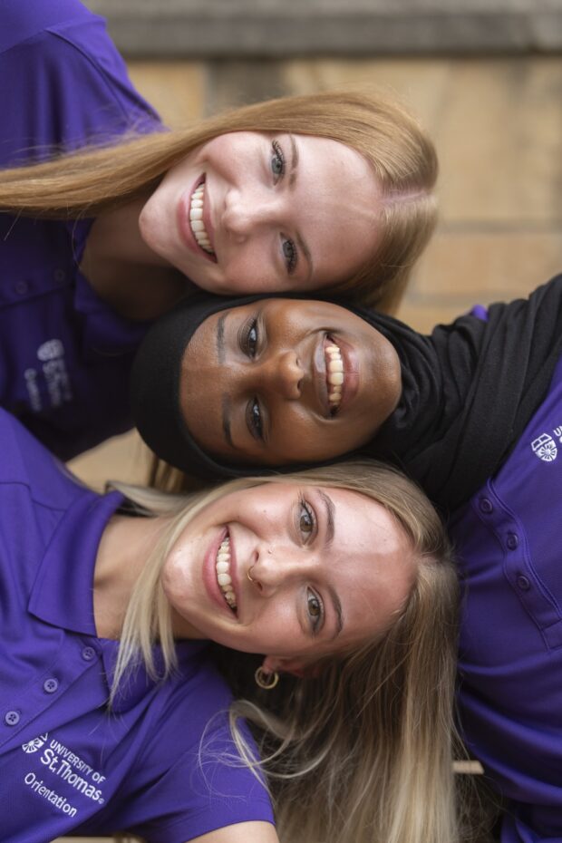 Three students pose for a photo.