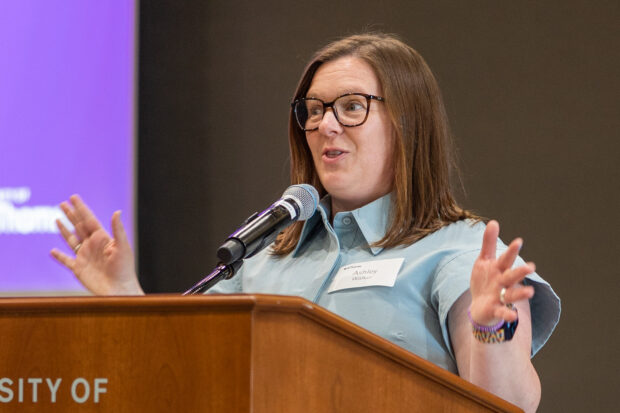 Dr. Ashley Walker speaking at a podium.
