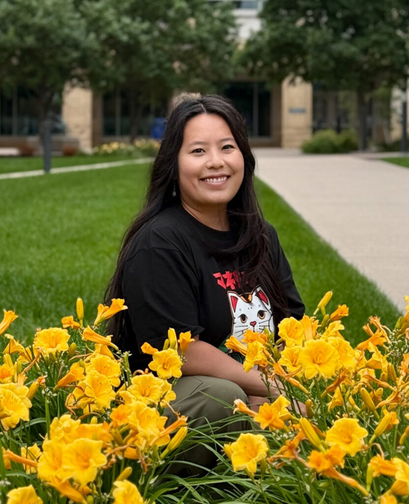 A student poses for a photo on the Minneapolis campus for St. Thomas.