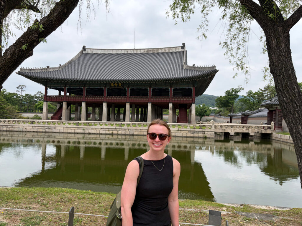 A student smiles for a photo abroad in Asia.