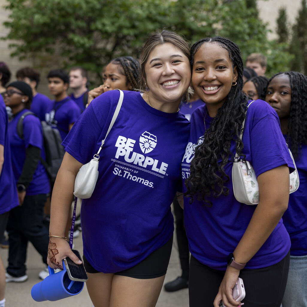 Two students smile for a photo.