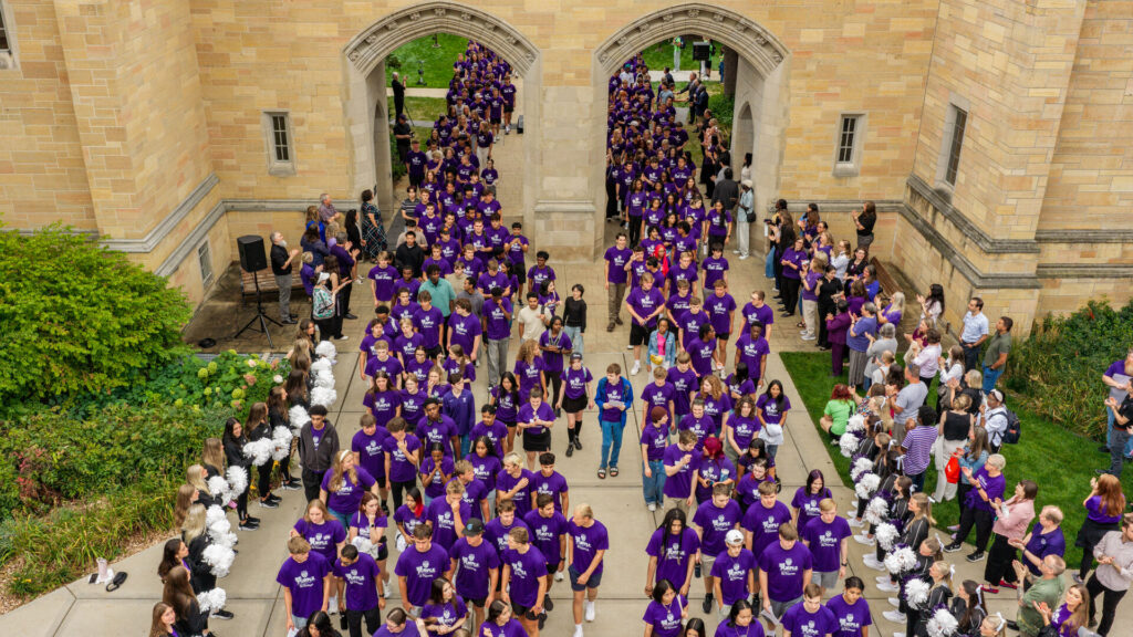 Students March Through the Arches.
