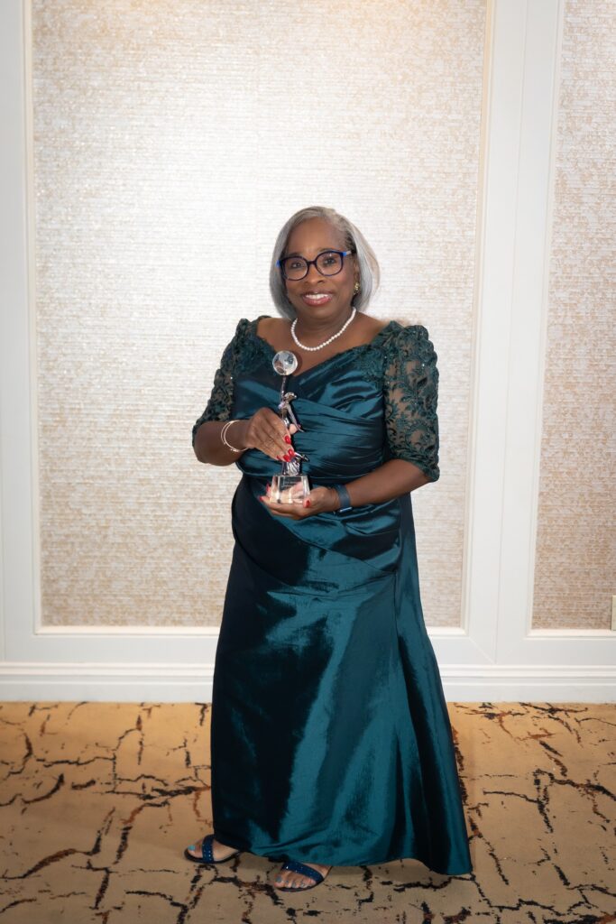 Dr. Aura Wharton-Beck poses with her award.
