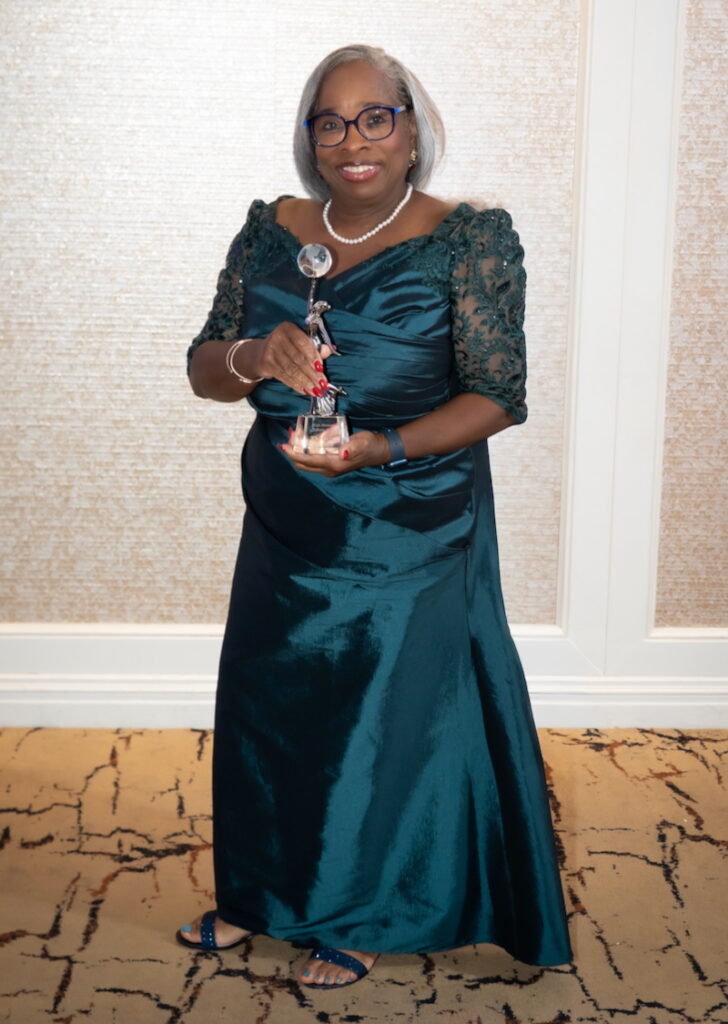Aura Wharton-Beck with Hispanic 100 trophy